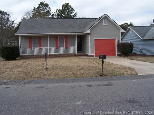 a front view of a house with a garden and garage