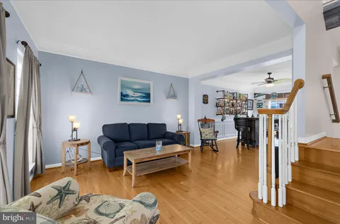 a dining room with furniture and wooden floor