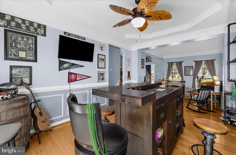 a kitchen with a dining table chairs and white cabinets