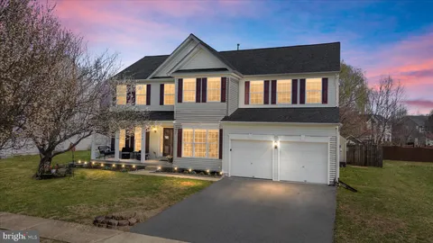 a front view of house with a garden and patio