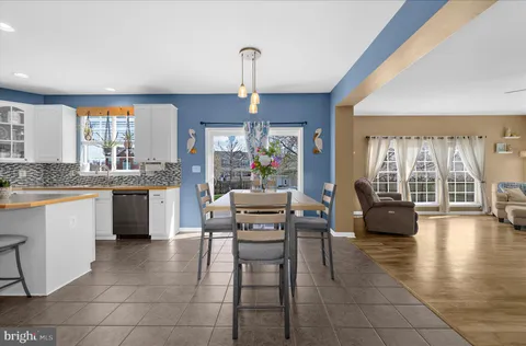 a living room with furniture and a large window with wooden floor