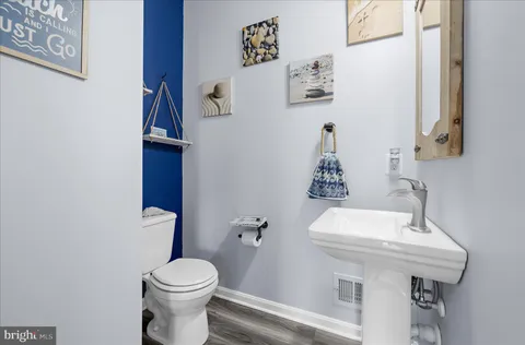 a bathroom with a tub a sink and a large mirror
