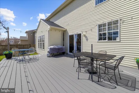 a view of a house with backyard sitting area and garden