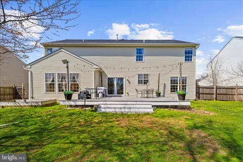 a view of a house with backyard sitting area and garden