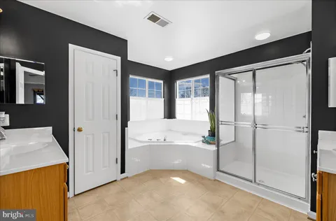 a view of a house with a yard and large tree