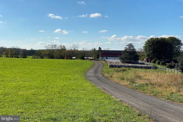 a view of a house with a yard and lake view