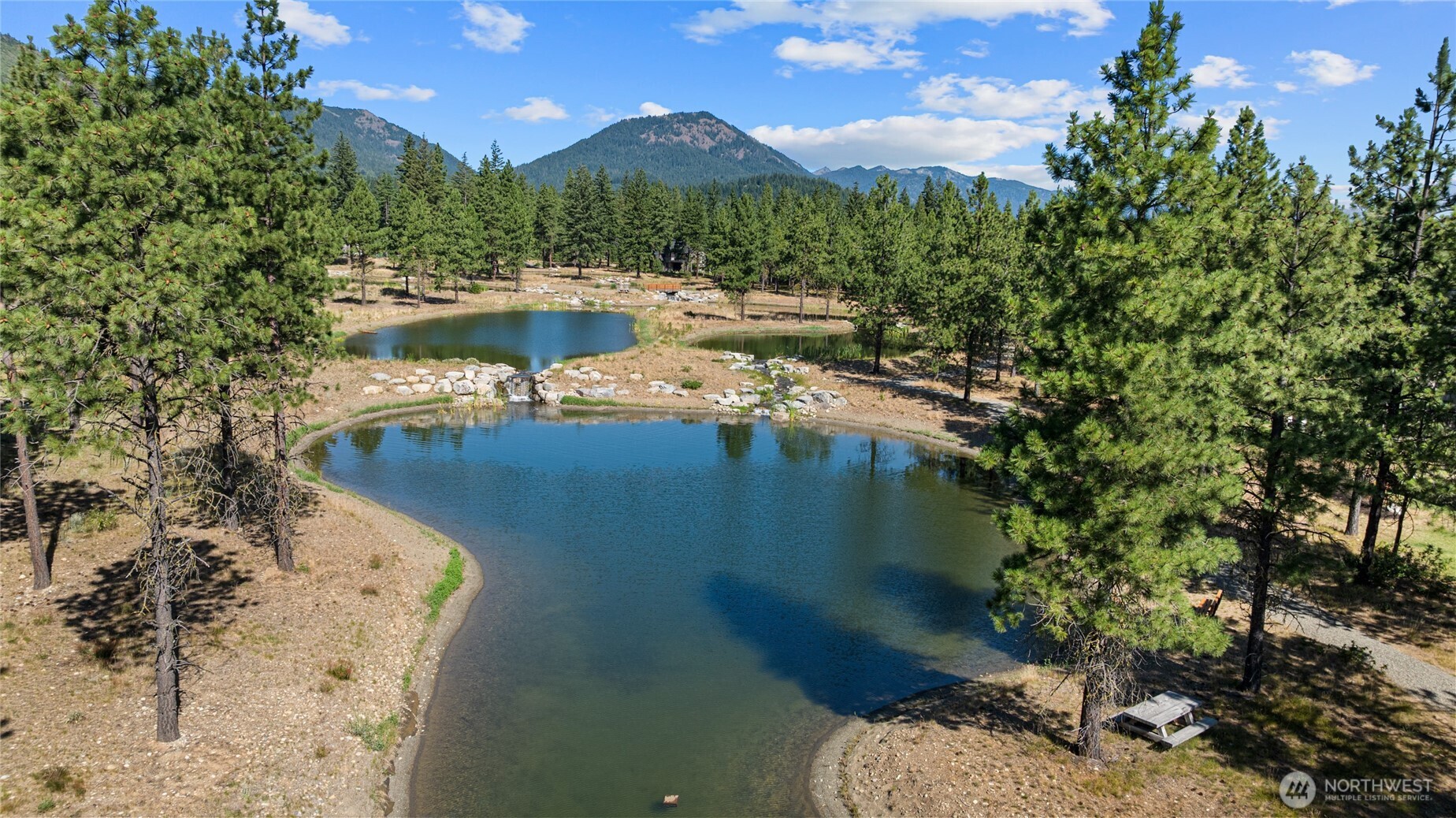 711 Ruby King Loop Cle Elum, WA 98922 - Photo 27 of 27 a view of a lake in front of residential houses with outdoor space