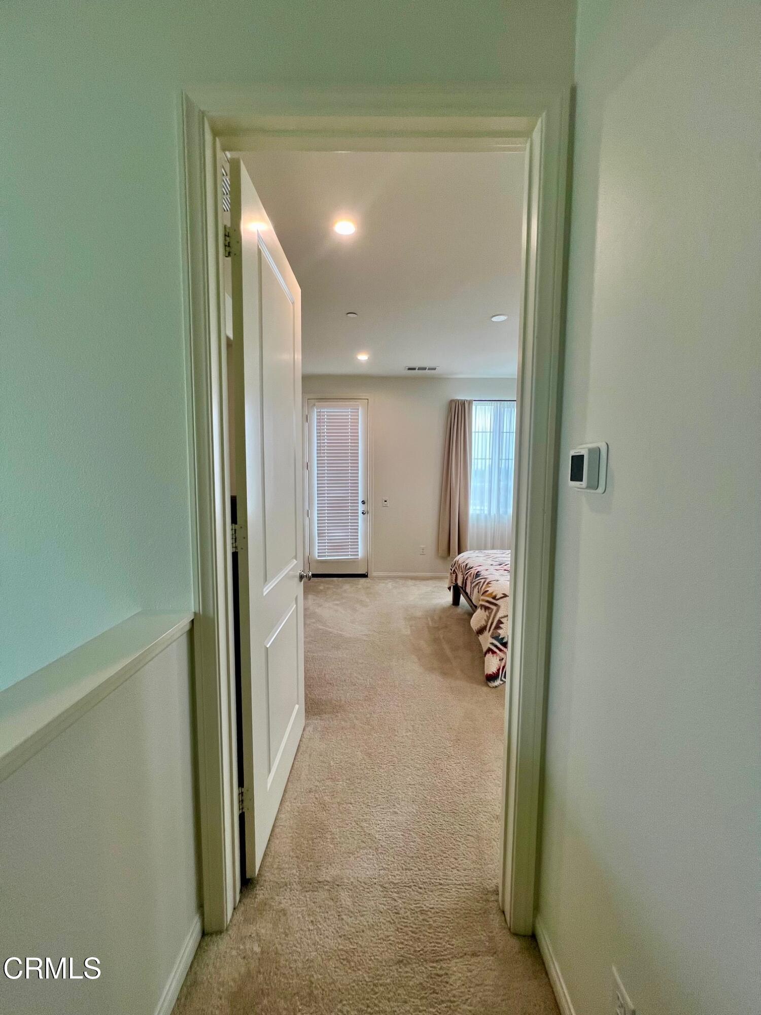394 Water Lily Street Fillmore, CA 93015 - Photo 15 of 39 a view of a hallway with bathroom and mirror
