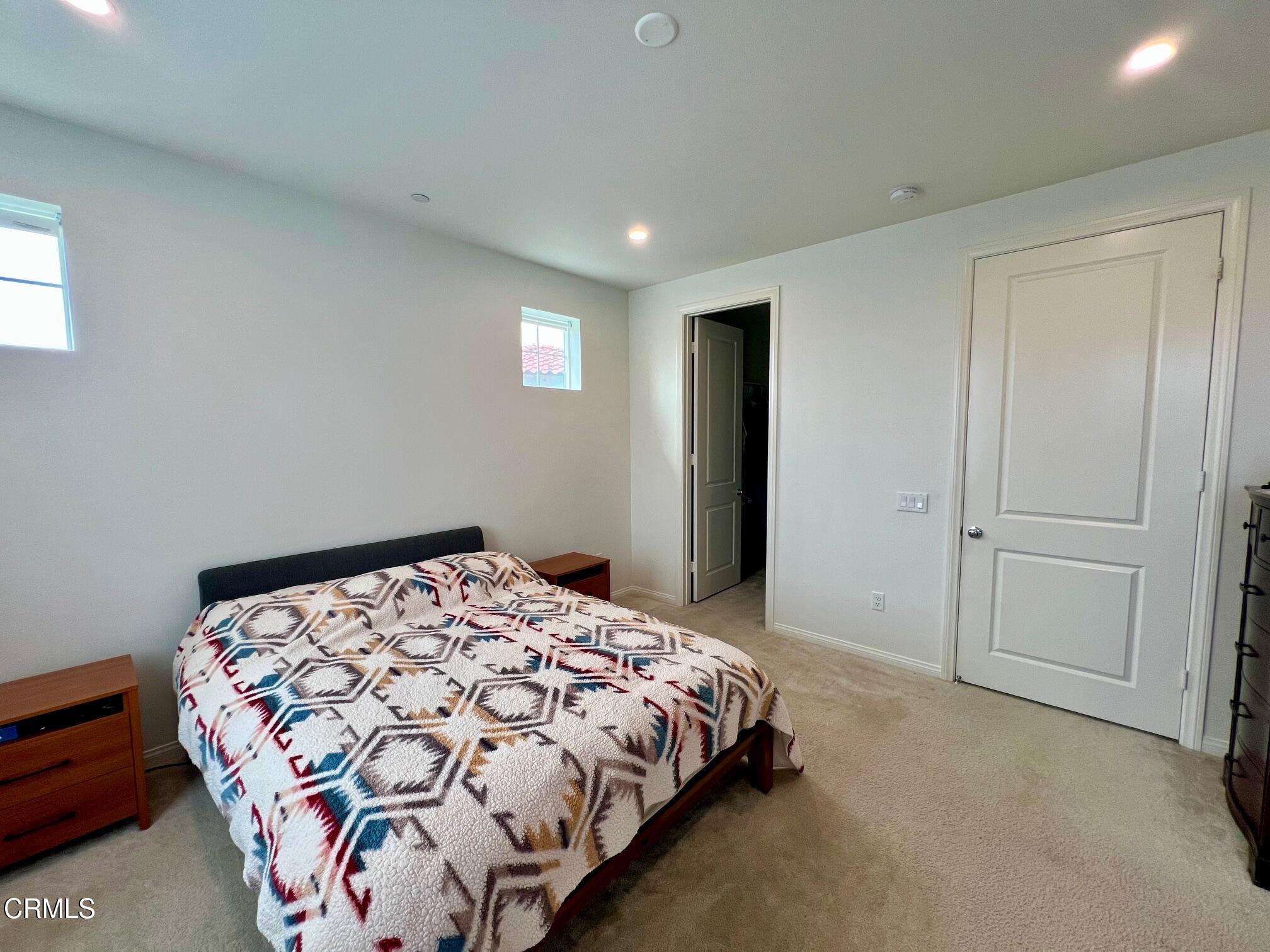 394 Water Lily Street Fillmore, CA 93015 - Photo 17 of 39 a bedroom with a bed and a painting on the wall