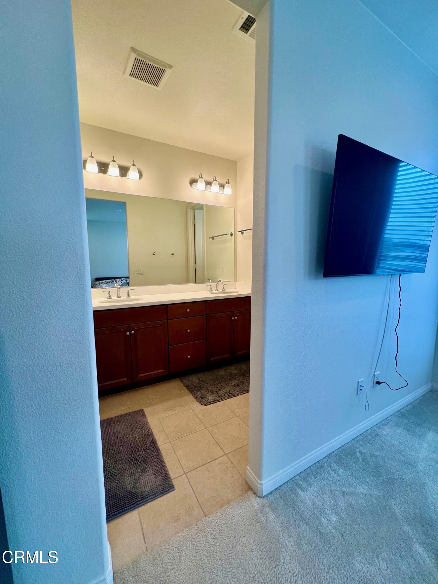 394 Water Lily Street Fillmore, CA 93015 - Photo 18 of 39 a view of bathroom with a sink and mirror