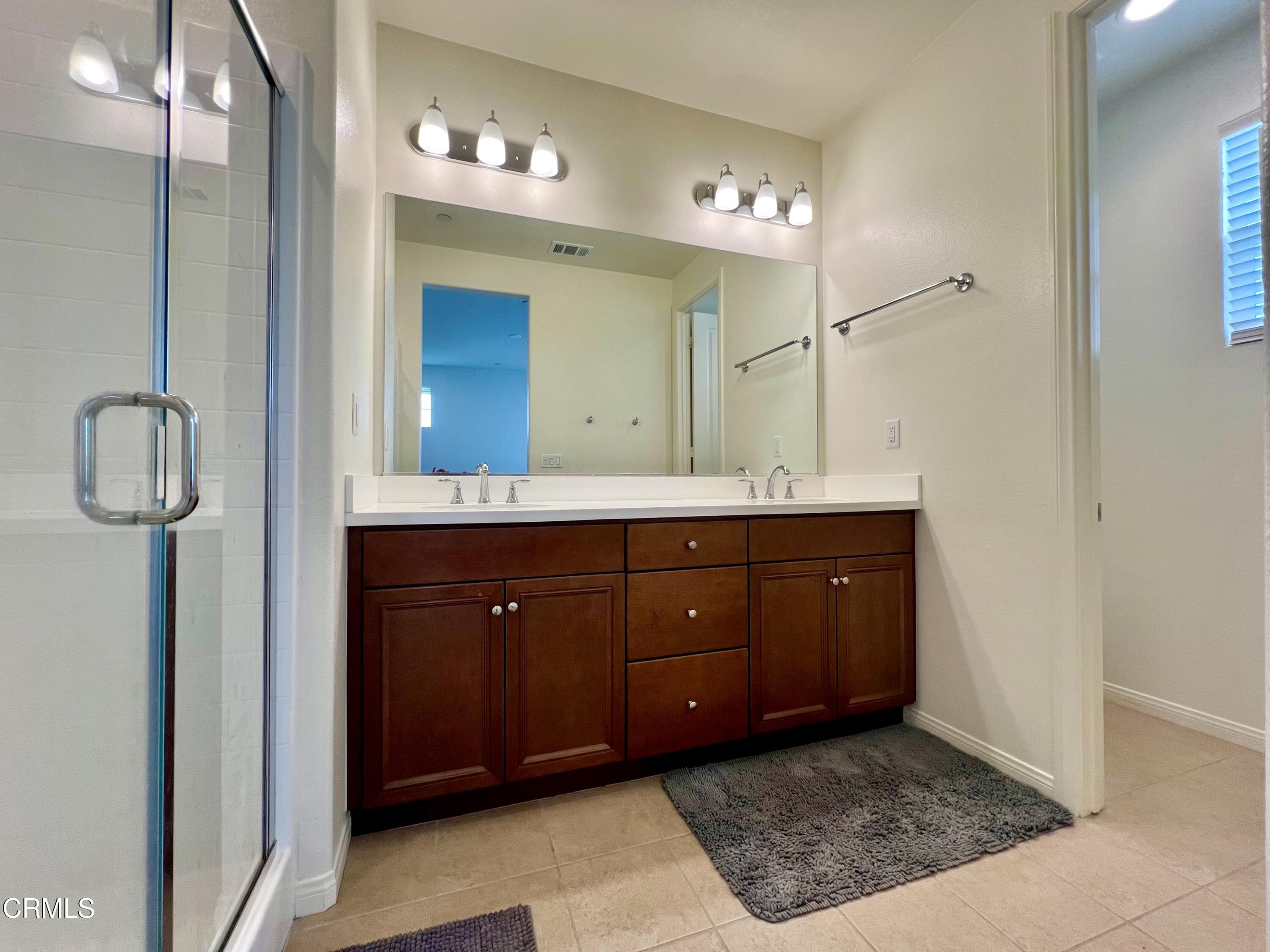 394 Water Lily Street Fillmore, CA 93015 - Photo 19 of 39 a bathroom with a sink vanity and a mirror