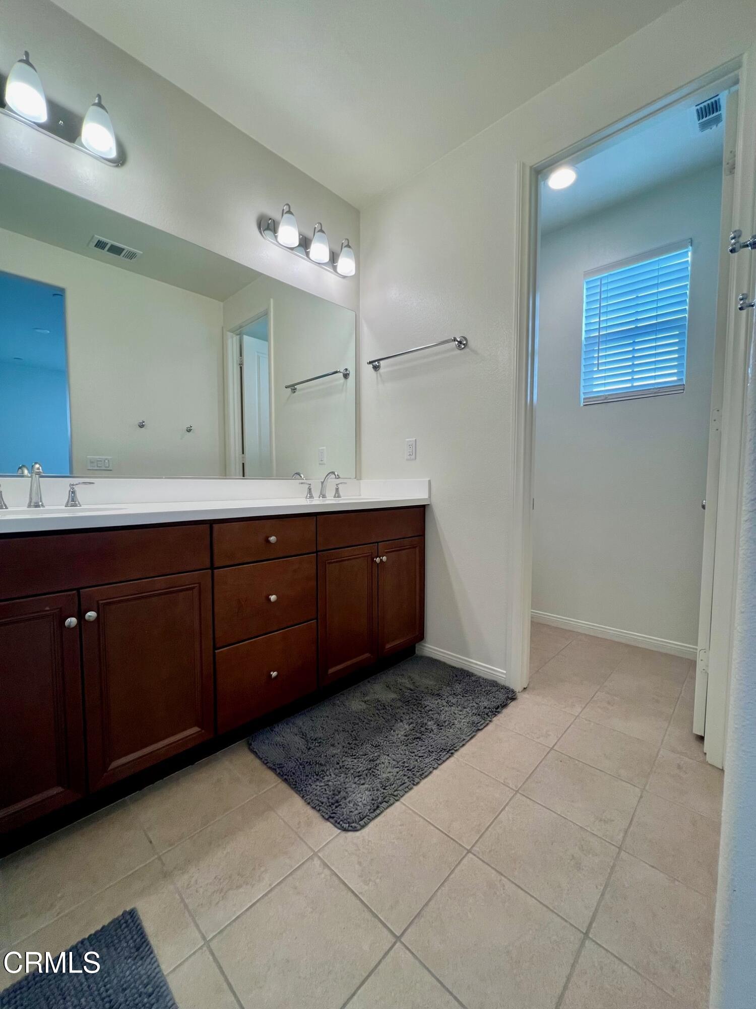 394 Water Lily Street Fillmore, CA 93015 - Photo 20 of 39 a bathroom with a sink and a mirror