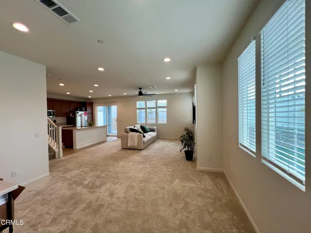 a view of a hallway with bathroom and mirror