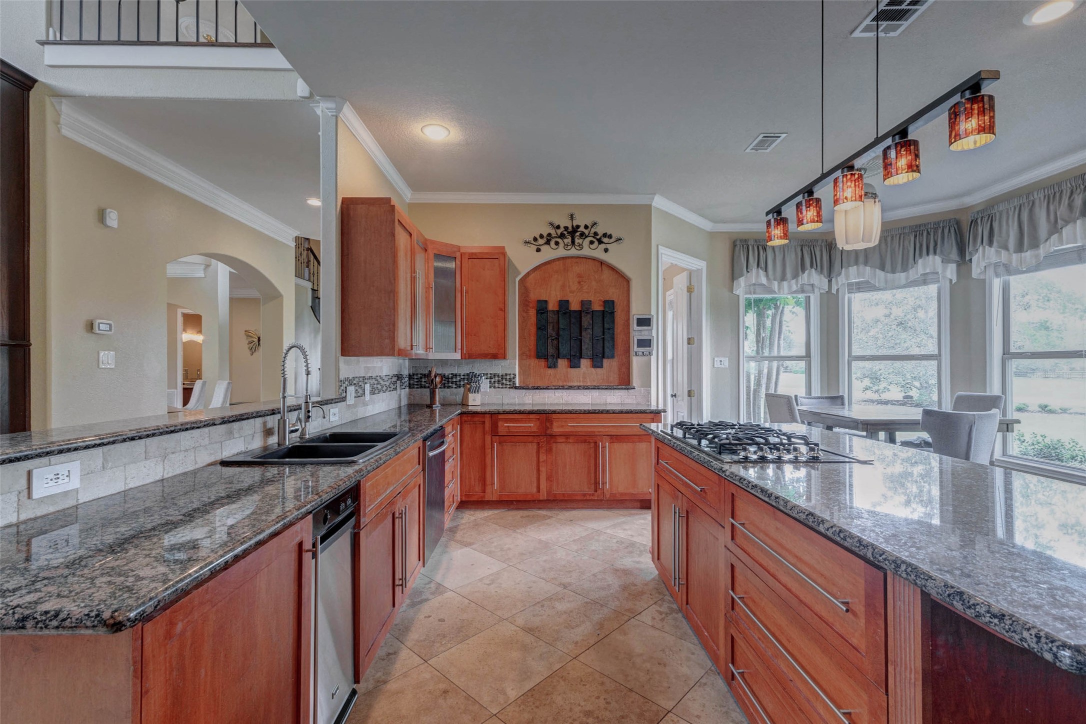 5610 Westerham Weston Lakes, TX 77441 - Photo 12 of 47 a large kitchen with granite countertop a sink and a stove