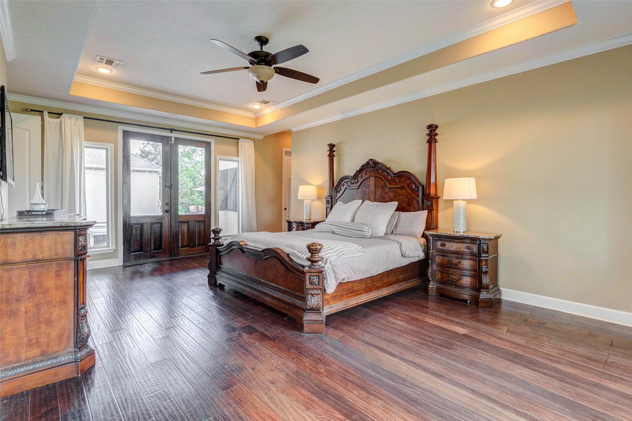 5610 Westerham Weston Lakes, TX 77441 - Photo 20 of 47 a bedroom with a bed and a chandelier