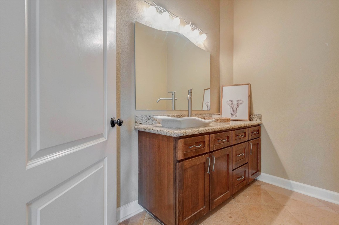 5610 Westerham Weston Lakes, TX 77441 - Photo 28 of 47 a bathroom with a granite countertop sink and a mirror