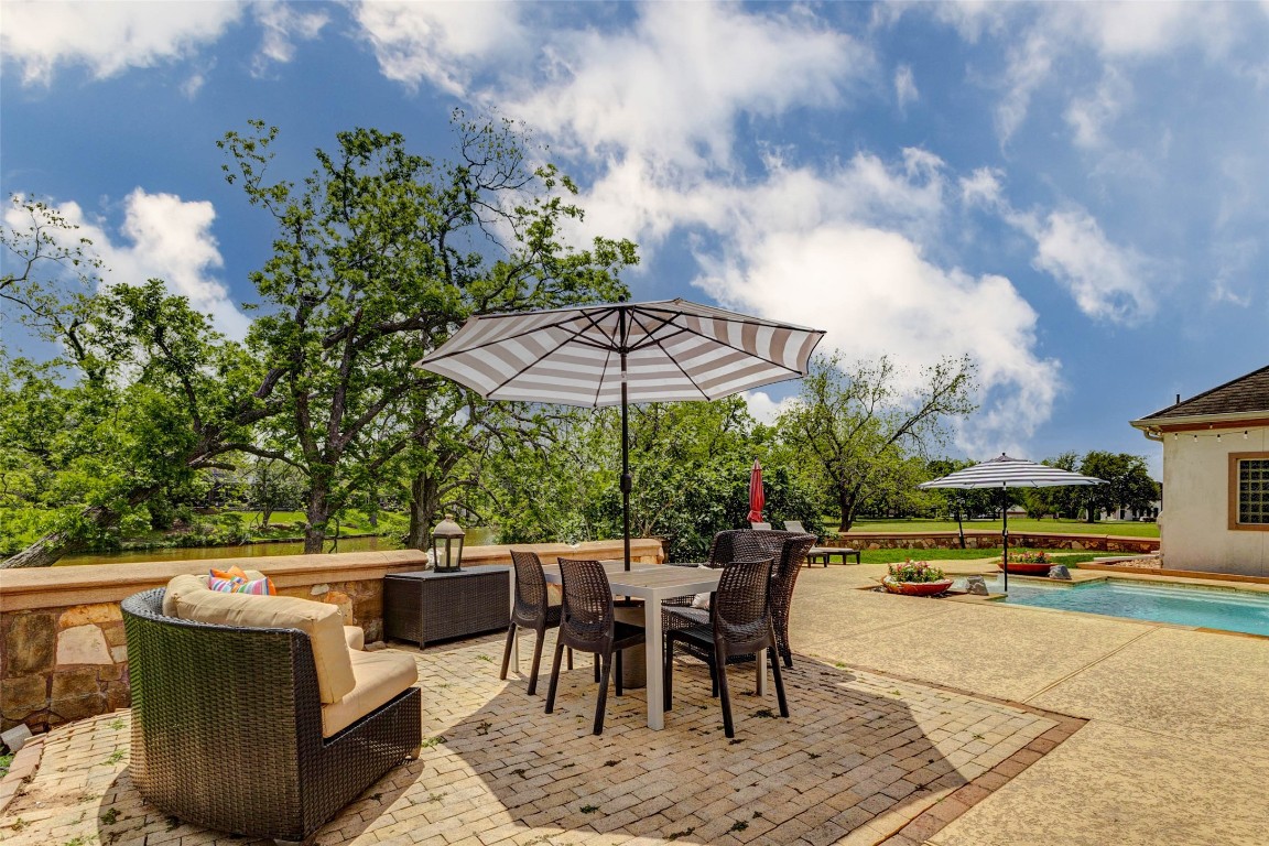5610 Westerham Weston Lakes, TX 77441 - Photo 44 of 47 a view of a patio with a table and chairs under an umbrella