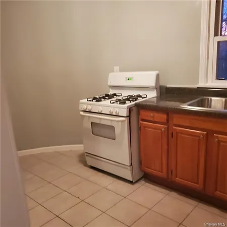 a stove top oven sitting inside of a kitchen