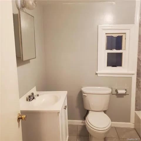 a bathroom with a sink toilet and mirror