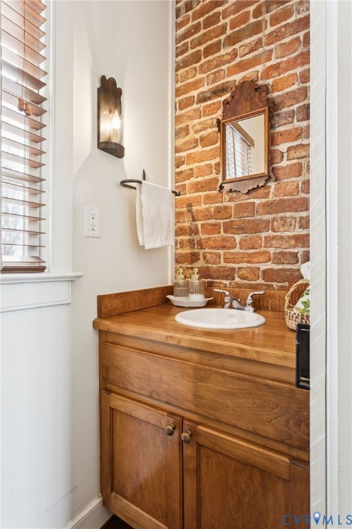 1685 Sweet Hall Road West Point, VA 23181 - Photo 20 of 47 The powder room with an exposed original brick wal