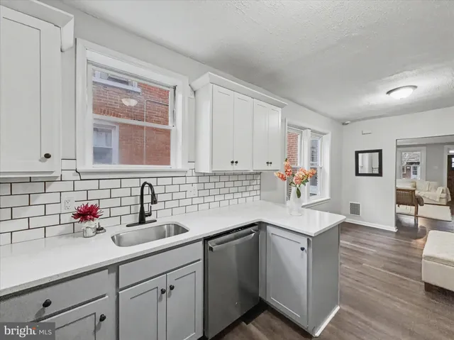 a kitchen with sink and cabinets