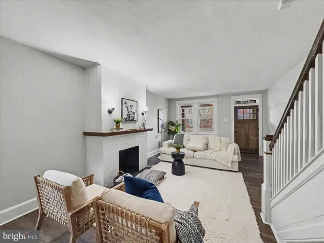 a living room with furniture a fireplace and a table