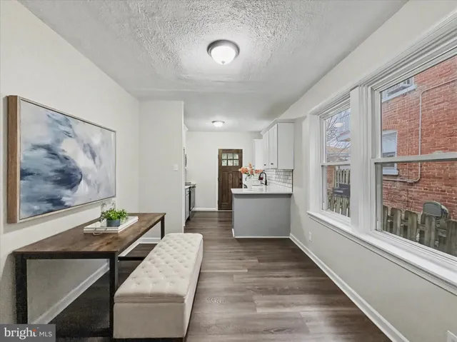 a view of a living room filled with furniture and window