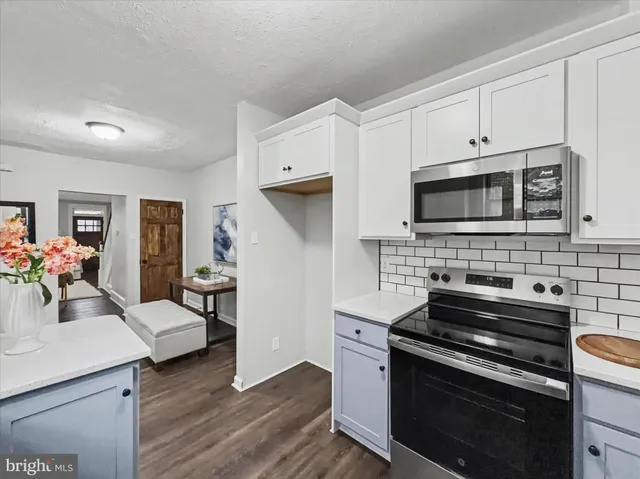 a kitchen with a stove and a microwave