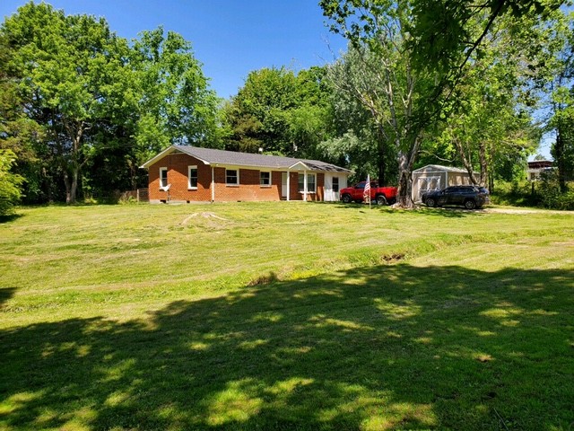 205 Locust Road Erin, TN 37061 - Photo 1 of 17 a front view of a house with a garden