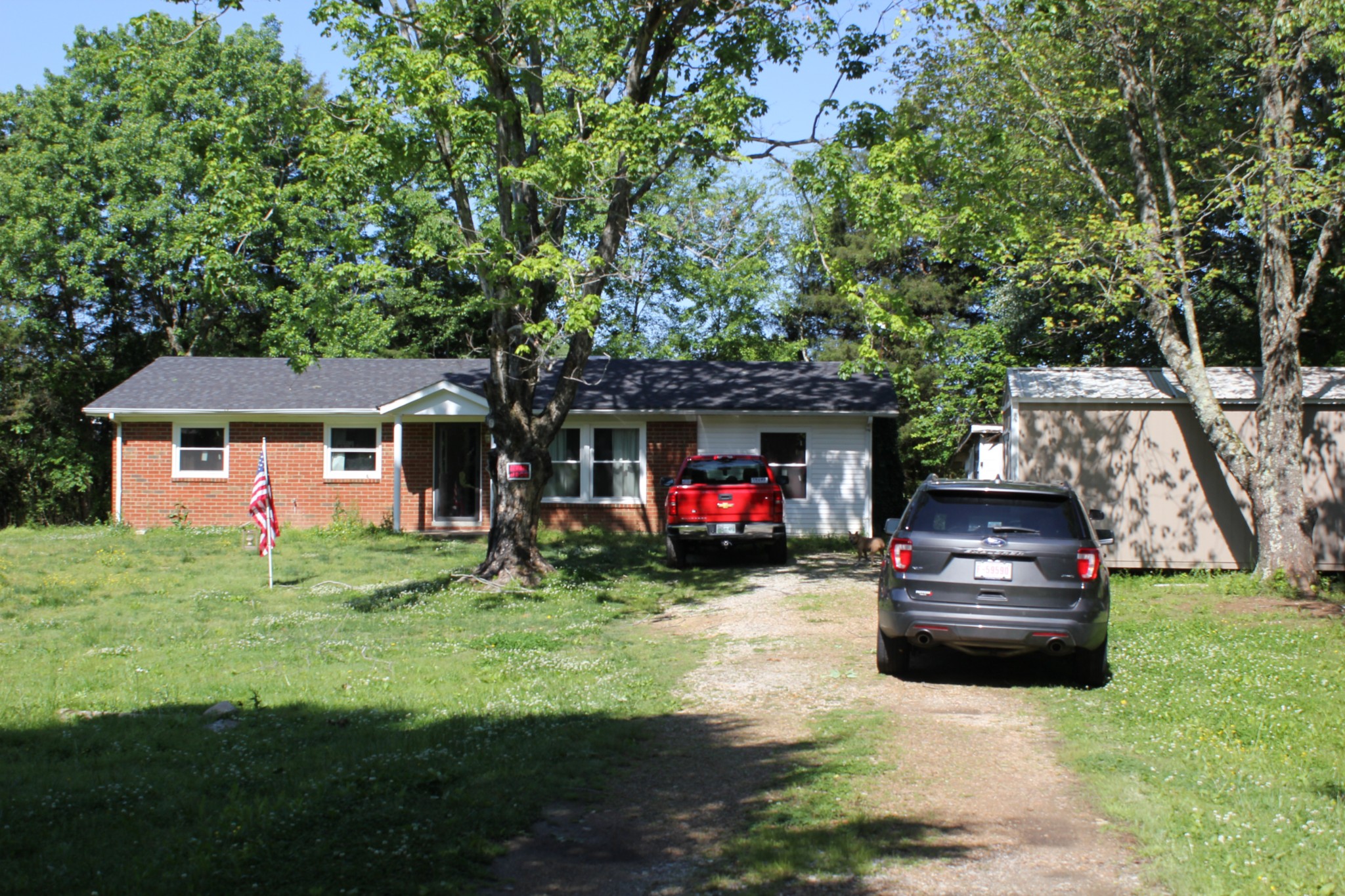 205 Locust Road Erin, TN 37061 - Photo 5 of 17 a front view of a house with a garden and trees