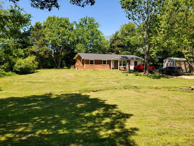 205 Locust Road Erin, TN 37061 - Photo 9 of 17 a swimming pool that has lawn chairs with wooden fence