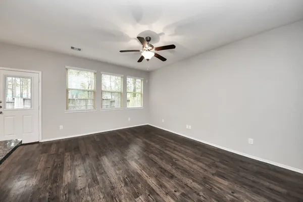 wooden floor in an empty room with a window