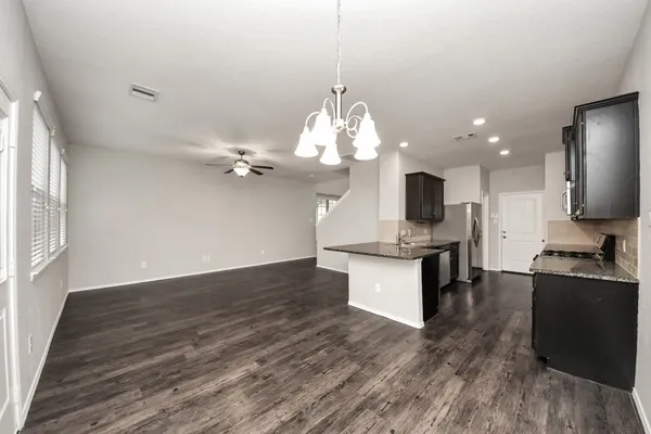 a kitchen with stainless steel appliances granite countertop a stove top oven a sink and dishwasher