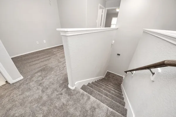 an empty room with a ceiling fan and a window