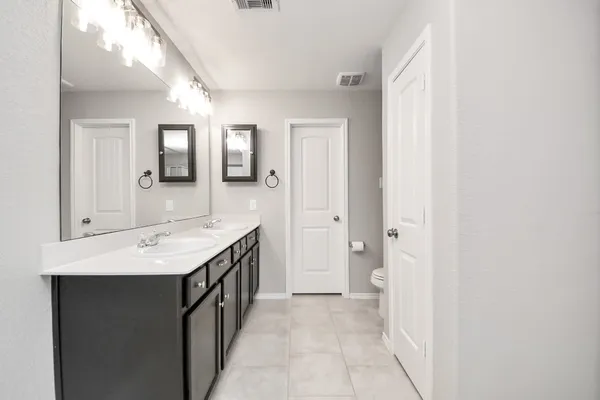 a front view of a house with a garden and garage