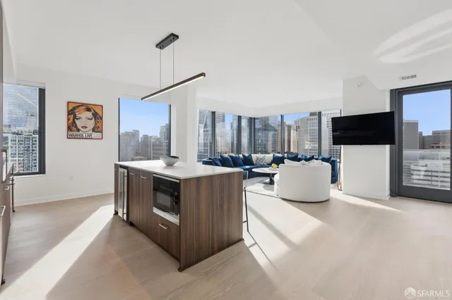 a living room with furniture a flat screen tv and a wall paintings