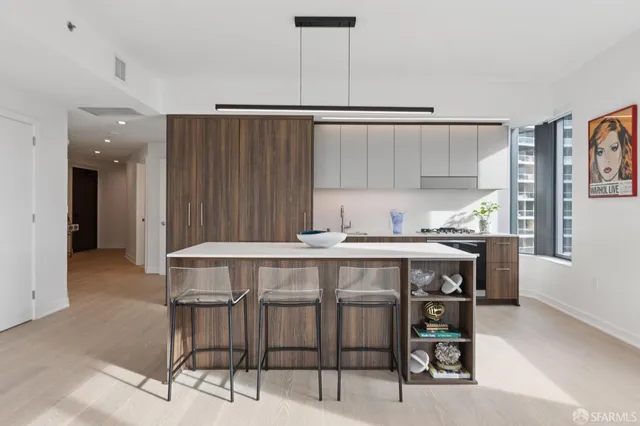 a kitchen with a wooden table chairs and refrigerator