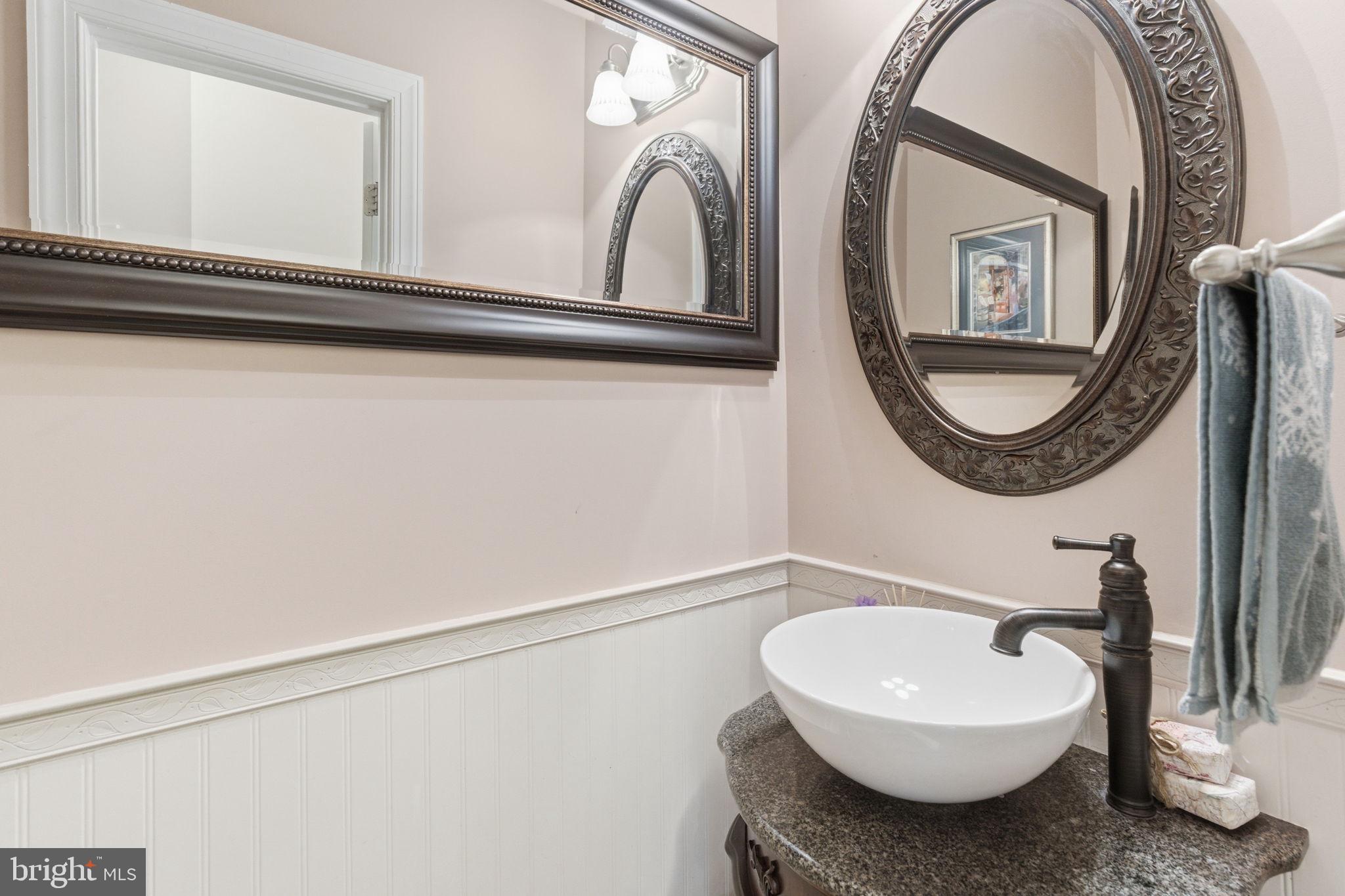 9 Deer Ridge Court Phoenix, MD 21131 - Photo 59 of 96 a bathroom with a sink and a mirror