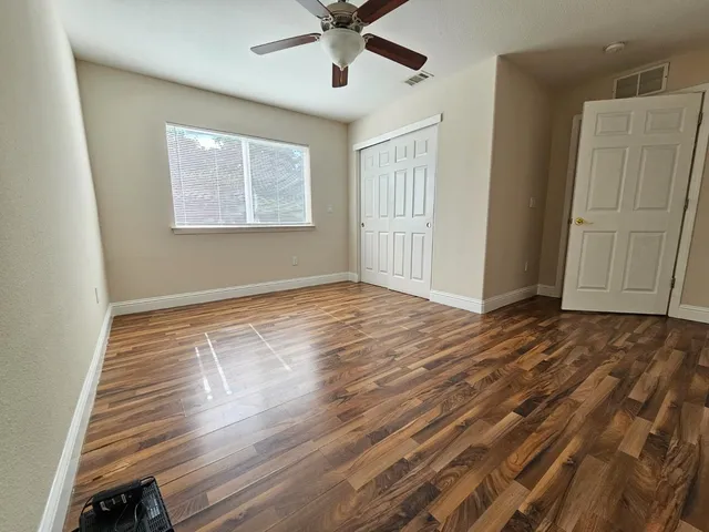 wooden floor in an empty room with a window