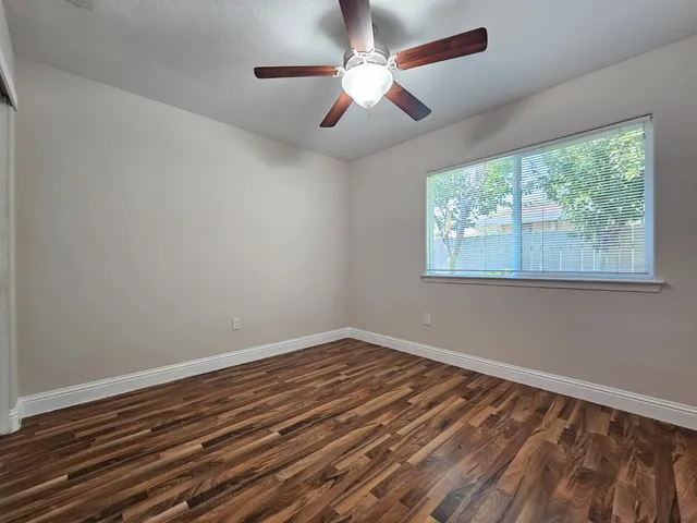 a view of room with window and ceiling fan