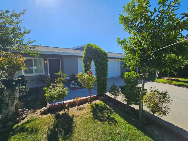 a view of a house with a yard and garden