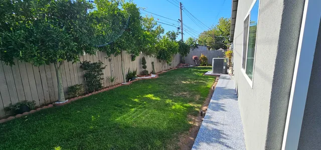 a view of a backyard with potted plants