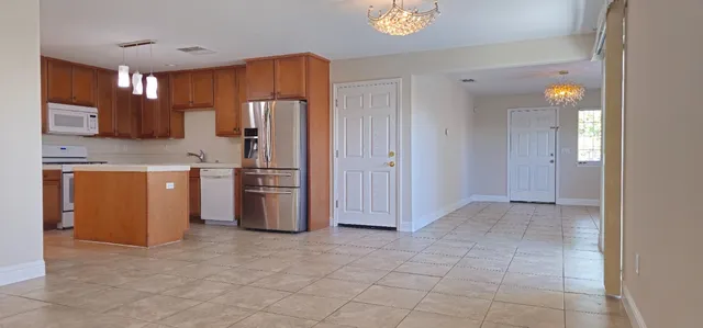 a kitchen with stainless steel appliances a refrigerator and a stove top oven
