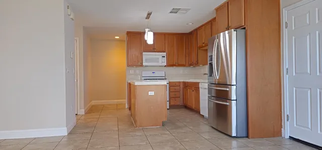 a kitchen with stainless steel appliances granite countertop a refrigerator and a sink