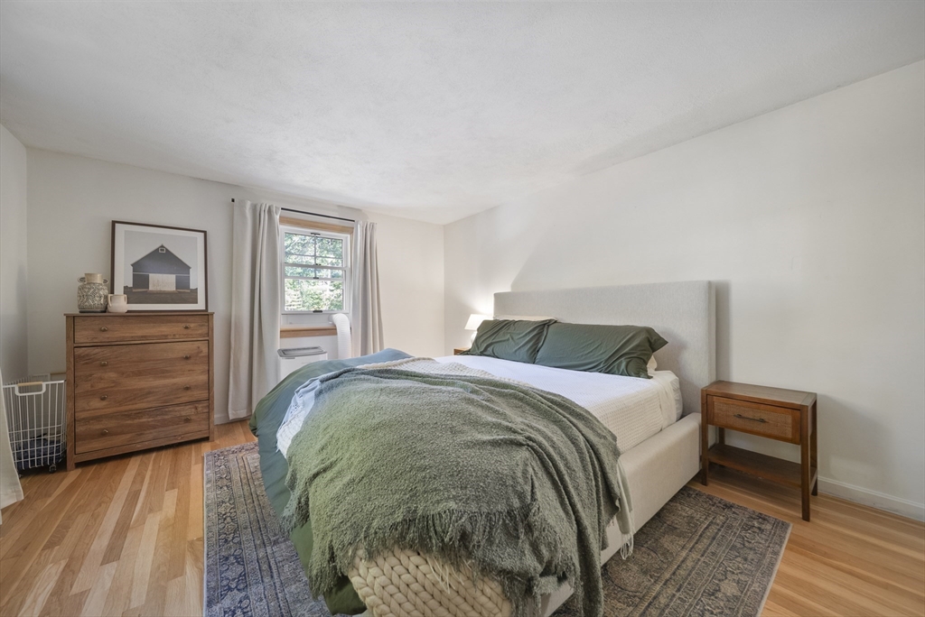 41 Searle Street Georgetown, MA 01833 - Photo 12 of 26 a bed sitting in a bedroom next to a window and dresser