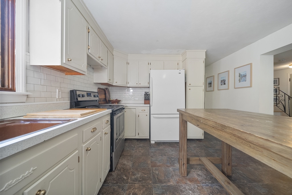 41 Searle Street Georgetown, MA 01833 - Photo 3 of 26 a kitchen with a sink a refrigerator and cabinets