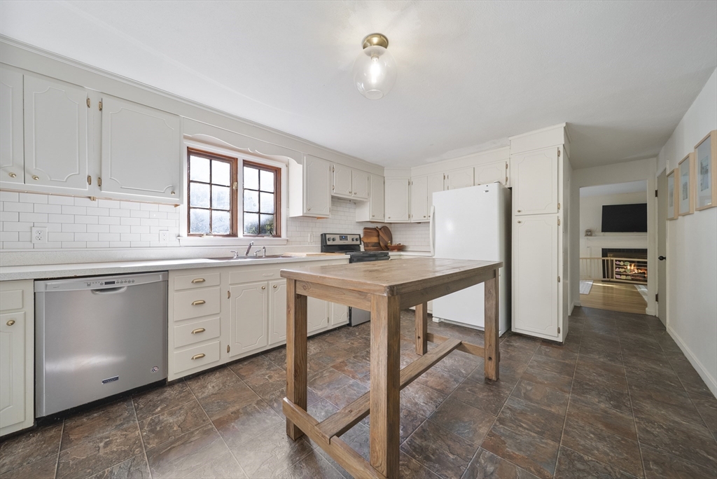 41 Searle Street Georgetown, MA 01833 - Photo 5 of 26 a kitchen with white cabinets and white appliances