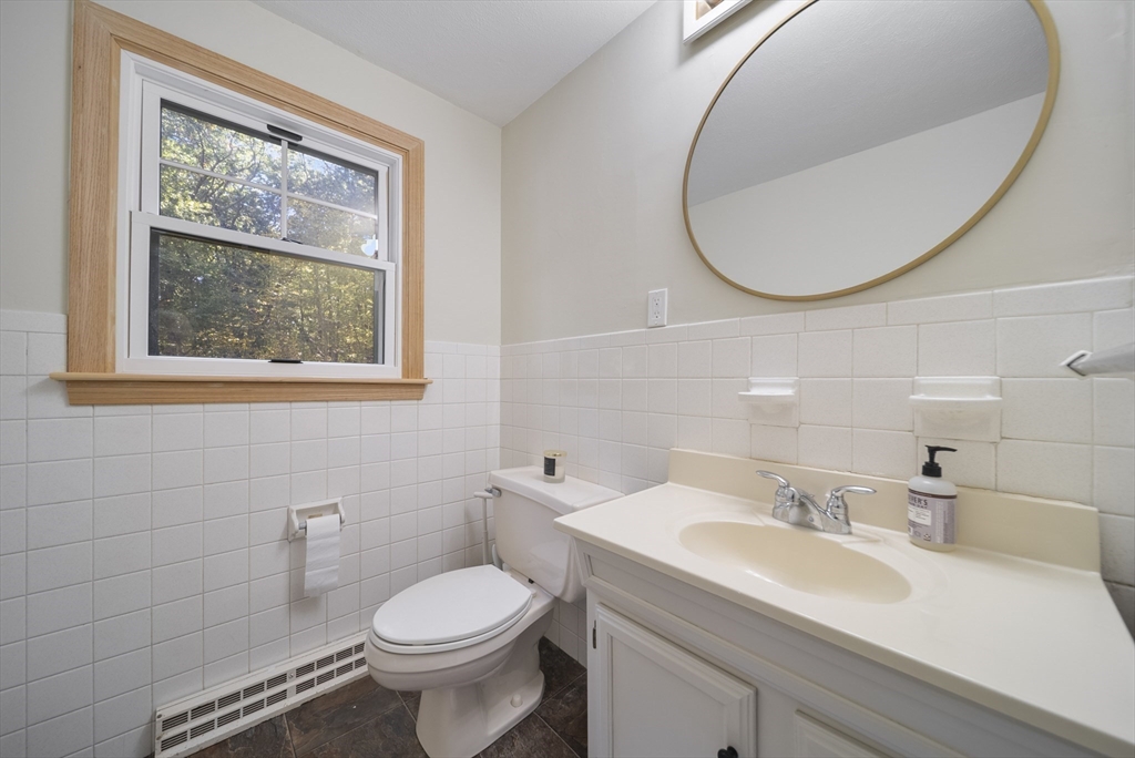 41 Searle Street Georgetown, MA 01833 - Photo 9 of 26 a bathroom with a sink a toilet and a mirror