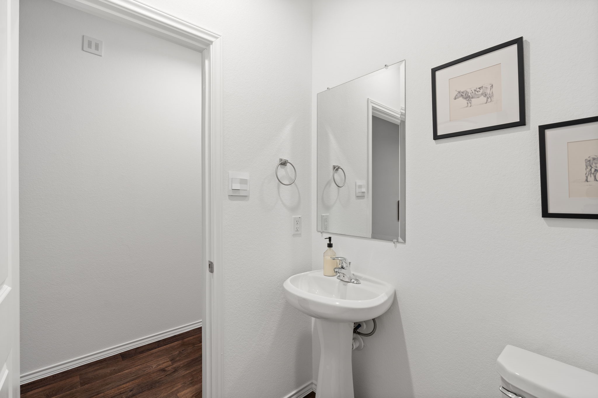 22306 Forest Gorge Lane Spring, TX 77373 - Photo 4 of 26 a bathroom with a sink and mirror with toilet