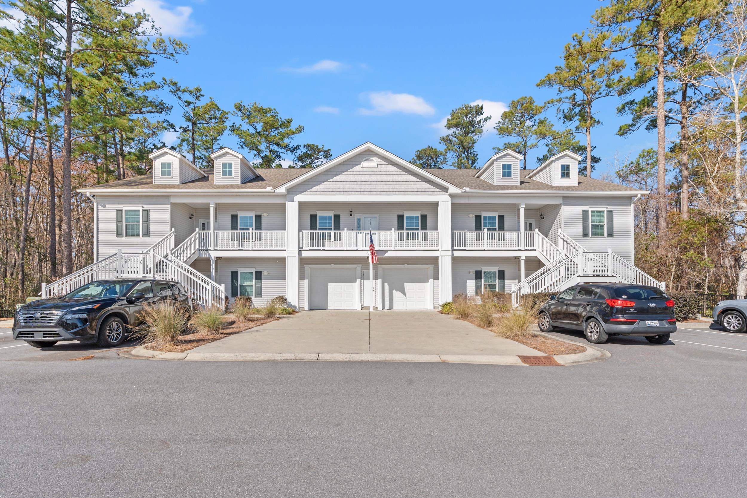 900 Jackline Place, Unit 202 Murrells Inlet, SC 29576 - Photo 11 of 39 Coastal inspired home with stairs, covered porch, an attached garage, and concrete driveway